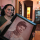 In this Dec. 2, 2011, photo, Michelle Duster, great-granddaughter of journalist and civil rights pioneer Ida B. Wells, holds a portrait of Wells in her home in Chicago’s South Side.
